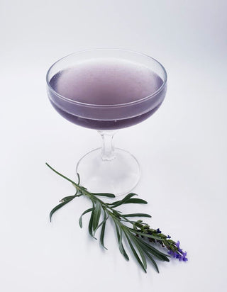 Purple Karu Distillery Cocktail in Martini glass with a sprig of lavender