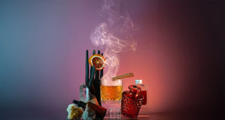 Affinity Mulled Cider with smoking glass, orange slice, and dark background